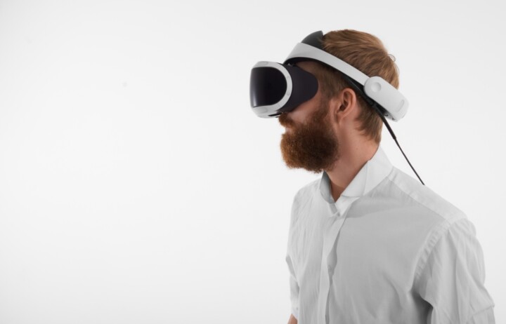 visual reality artificial intelligence concept profile shot bearded red haired young man wearing vr headset uai